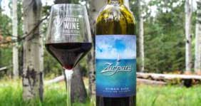 Zarpara Syrah bottle with glass with trees in background